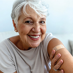 Smiling mature woman with bandage on arm